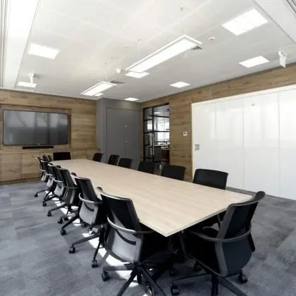 fitted-out meeting room with dark composite panel wall